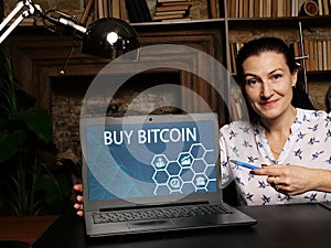 Business concept about BUY BITCOIN with sign on the computer. often described as aÂ cryptocurrency, a virtual currency or a